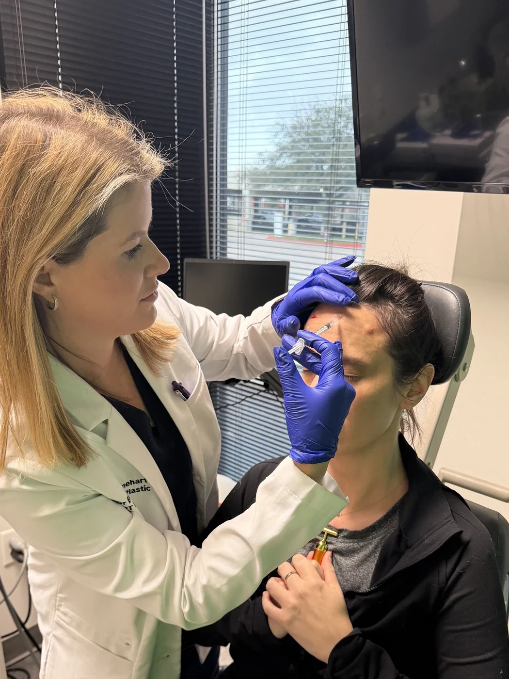 Dr. Bailey Minehart treating a patient at Las Colinas Facial Plastic Surgery